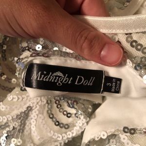 White sequence dress; knee length, form fitting.